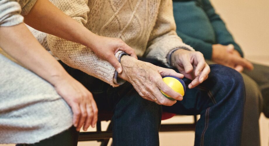 elderly person holding ball