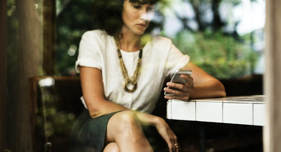 woman looks at phone