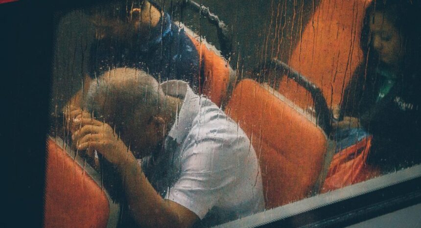 man on bus in rain