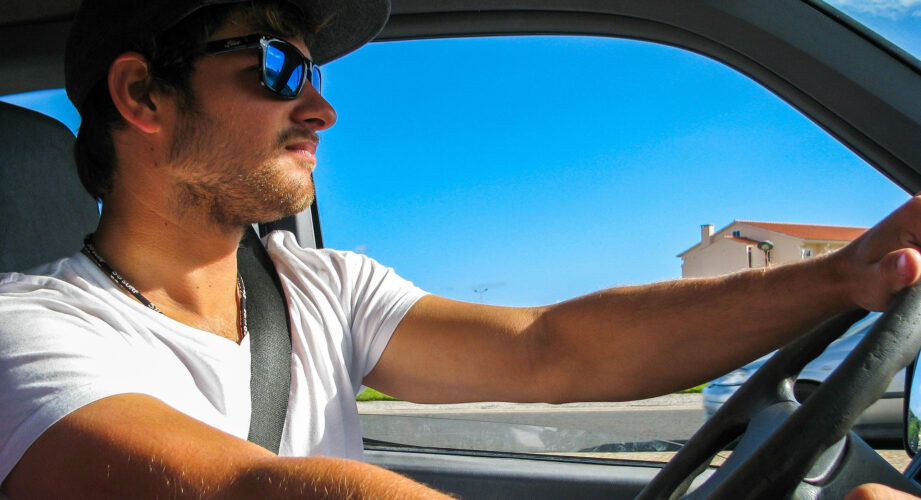 Man driving wearing seat belt