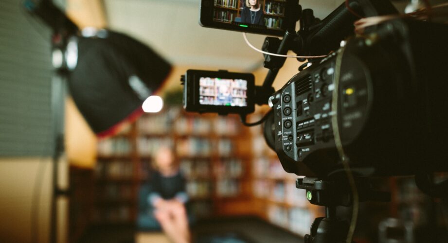 A camera facing an out-of-focus interview subject.