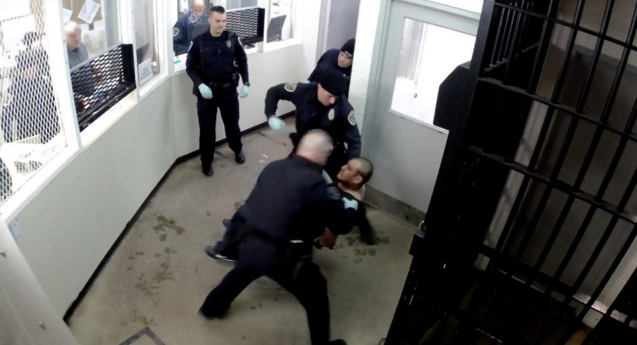 Screenshot of video showing police hitting handcuffed man